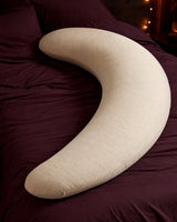 Oversized cream crescent body pillow on plum bedding